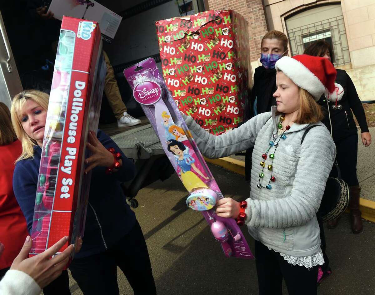 Faith Tremblay of Madison, right, helps to unload some of the 5,000 toys collected in the 4th Faith’s Annual Toy Drive at Yale New Haven Children’s Hospital on Dec. 14, 2021.