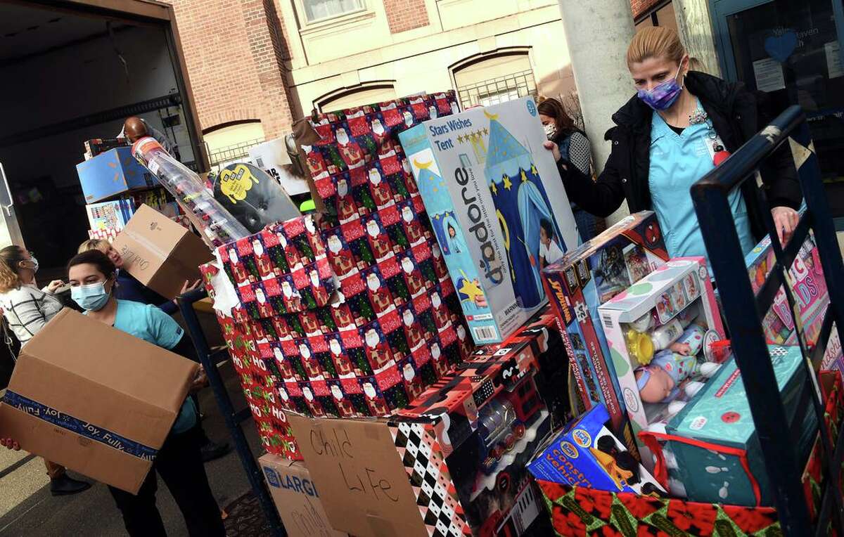 Child Life Specialist Michaela Gertz, right, helps unload some of the 5,000 toys collected in the 4th Faith’s Annual Toy Drive at Yale New Haven Children’s Hospital on Dec. 14, 2021.