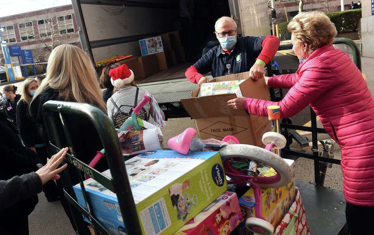 Volunteer Hyman Glick, center, helps unload some of the 5,000 toys collected in the 4th Faith’s Annual Toy Drive at Yale New Haven Children’s Hospital on Dec. 14, 2021.