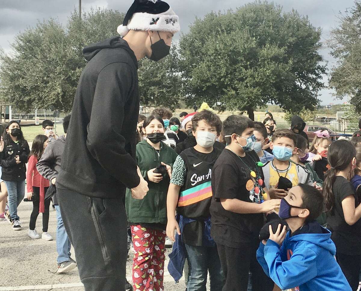 The Spurs' Zach Collins meets with students at Sun Valley Elementary School on Tuesday, Dec. 14, 2021, an a pep rally to promote youth literacy sponsored by Spurs Give and Whataburger.