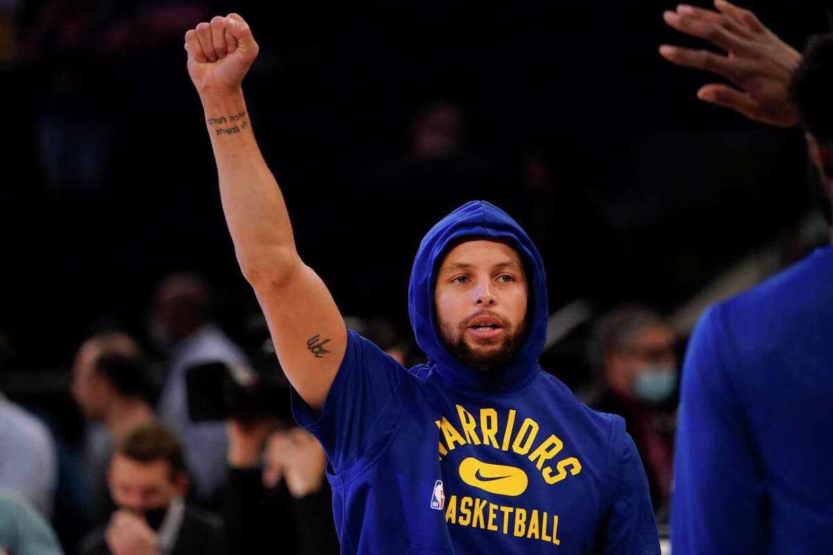 Golden State Warriors guard Stephen Curry gestures as he warms up before an NBA basketball game against the New York Knicks, Tuesday, Dec. 14, 2021, at Madison Square Garden in New York.