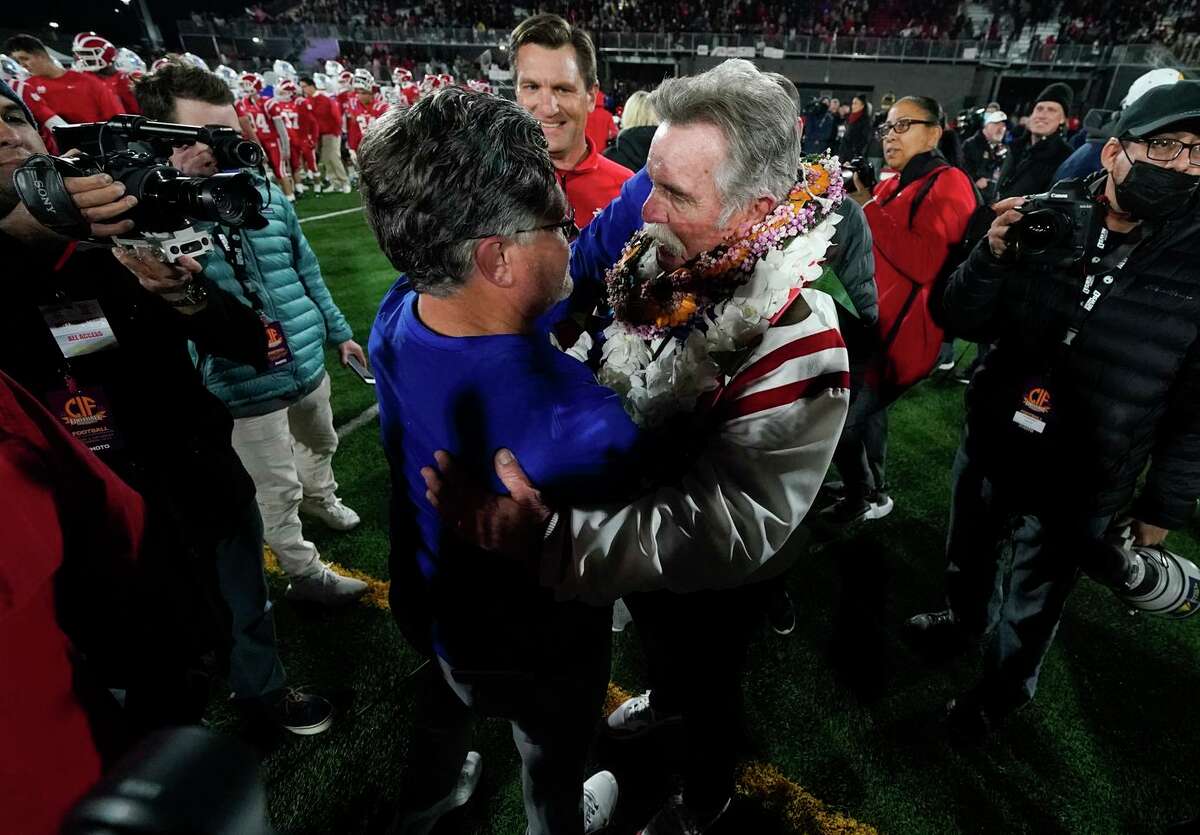 Serra head coach Patrick Walsh, center left, greets Mater Dei head coach Bruce Rollinson after the Monarchs’ 44-7 victory in the Open Division title game.