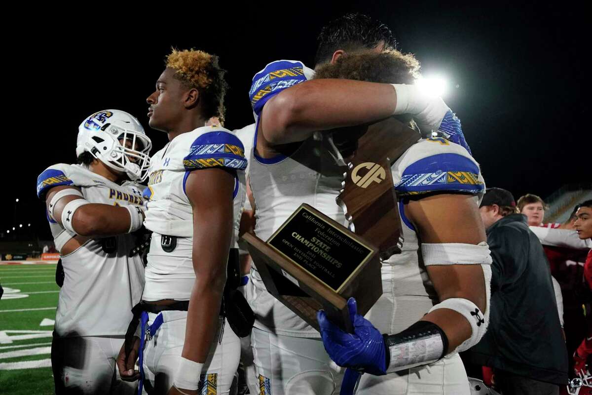 Serra football players react after receiving a second place trophy after the 2021 CIF Open Division high school football state championship game against Mater Dei Saturday, Dec. 11, 2021, in Mission Viejo Calif. (AP Photo/Ashley Landis )