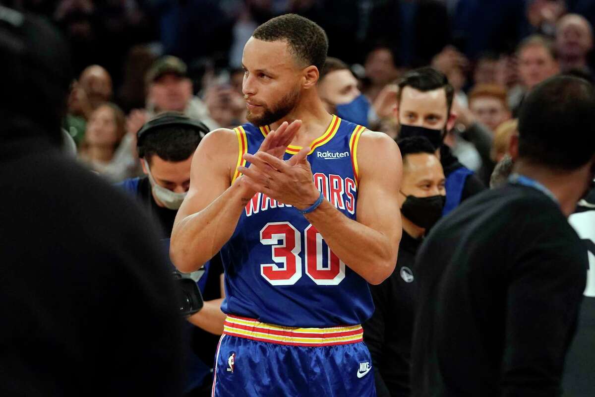 Golden State Warriors guard Stephen Curry reacts after scoring a 3-point basket during the first half of an NBA basketball game against the New York Knicks, Tuesday, Dec. 14, 2021, at Madison Square Garden in New York. Curry hit his 2,974th career 3-pointer Tuesday night, breaking the record set by Ray Allen. (AP Photo/Mary Altaffer)