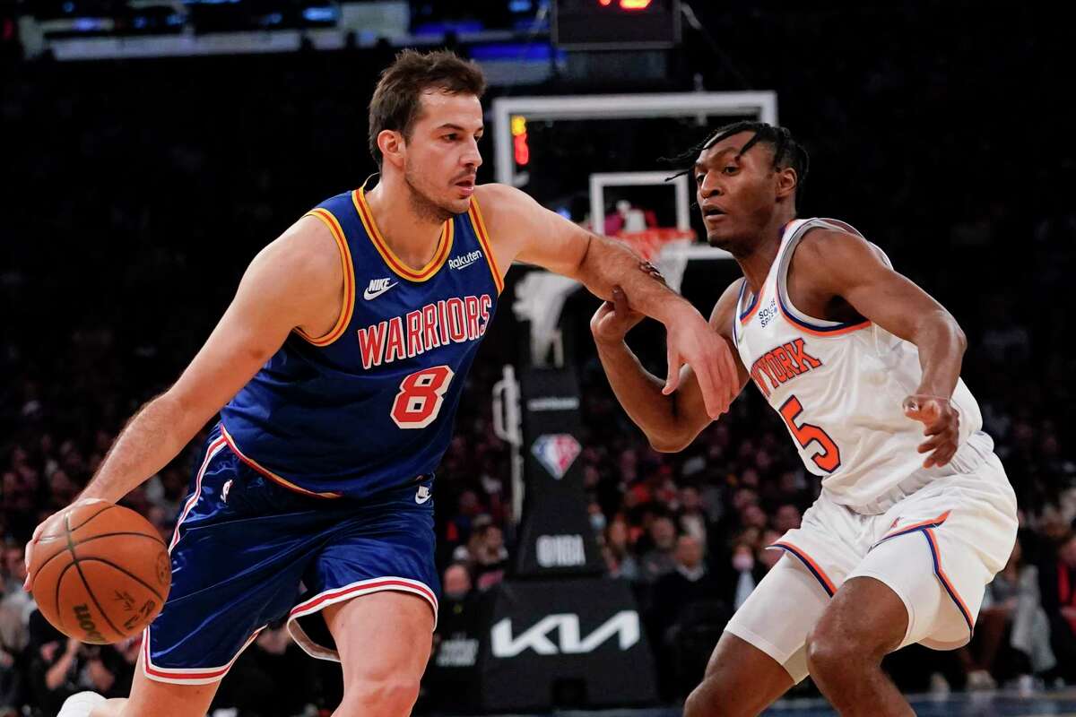 Golden State Warriors forward Nemanja Bjelica (8) drives to the basket against New York Knicks guard Immanuel Quickley (5) during the first half of an NBA basketball game, Tuesday, Dec. 14, 2021, at Madison Square Garden in New York. (AP Photo/Mary Altaffer)