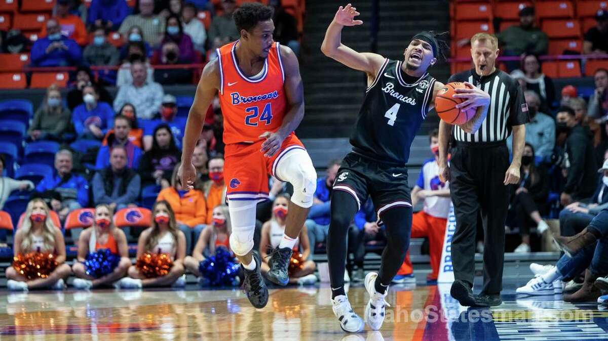 Boise State forward Abu Kigab forces a turnover on a loose ball as Santa Clara guard Giordan Williams runs out of bounds looking for a foul during the first half of an NCAA college basketball game Tuesday, Dec. 14, 2021 in Boise, Idaho. (Darin Oswald/Idaho Statesman via AP)