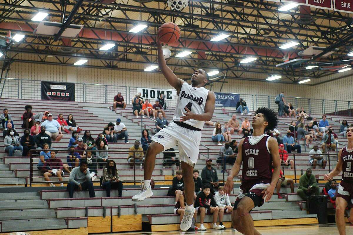 Pearland’s Charles Clark (4) coasts in for a layup past Clear Creek’s Caleb Barajas (0) Tuesday at Pearland High School.