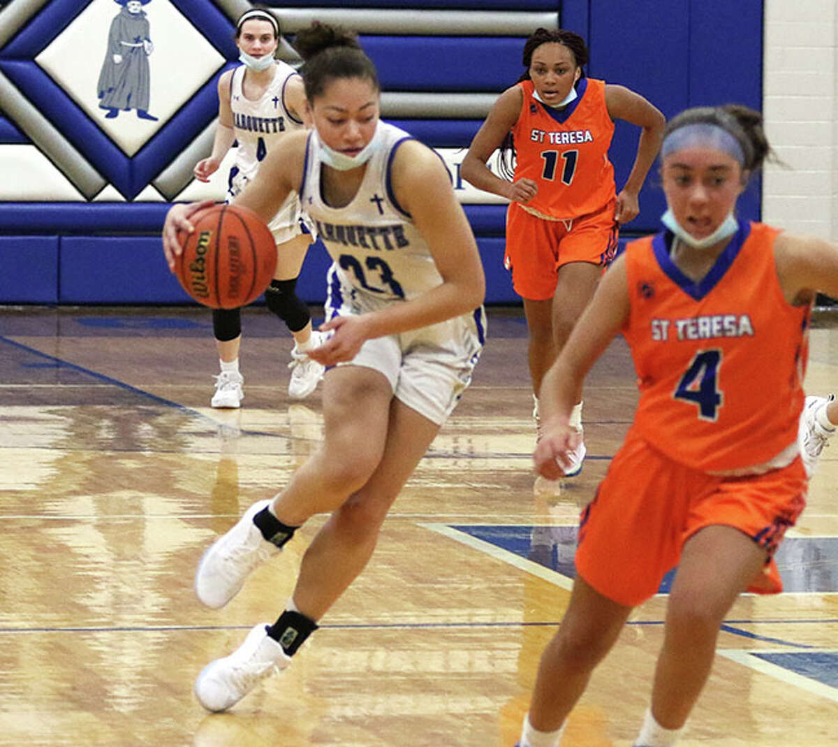 Marquette's Alyssa Powell (left), shown bringing the ball upcourt against Decatur St. Teresa earlier this month in Alton, had 20 points and 12 rebounds in Wednesday's loss at East St. Louis.