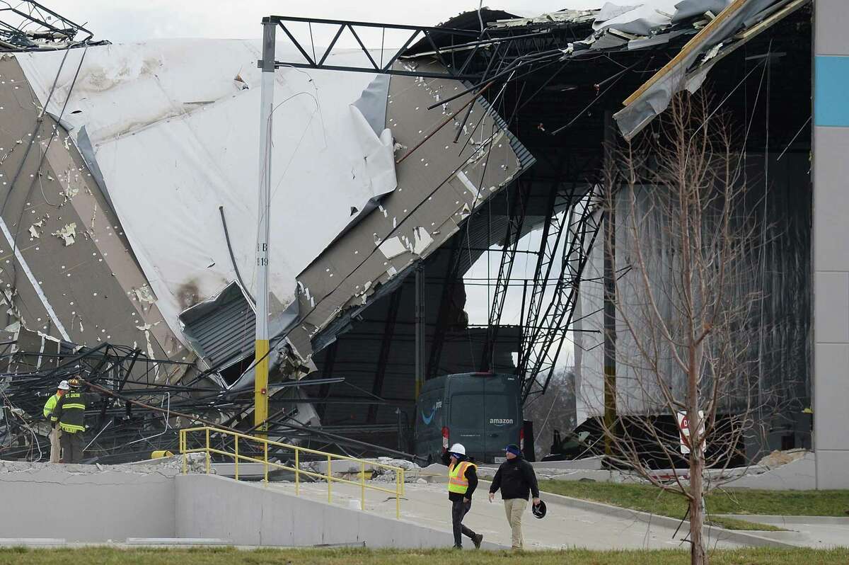 EDWARDSVILLE, IL - DECEMBER 11: Safety personnel and first responders survey a damaged Amazon Distribution Center on December 11, 2021 in Edwardsville, Illinois. According to reports, the Distribution Center was struck by a tornado Friday night. Emergency vehicles arrived to start rescue operations for workers believed to be trapped inside. (Photo by Michael B. Thomas/Getty Images) *** BESTPIX ***