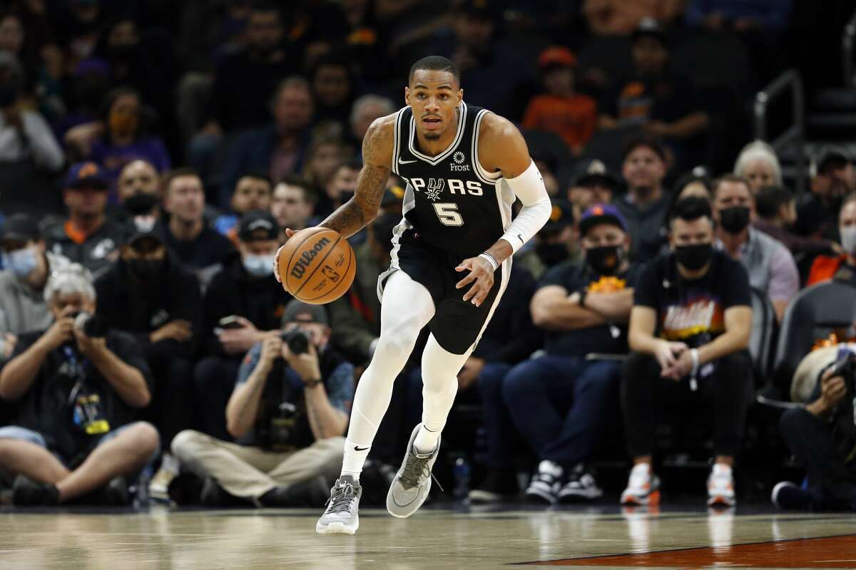 PHOENIX, ARIZONA - DECEMBER 06: Dejounte Murray #5 of the San Antonio Spurs dribbles the ball during the first half against the Phoenix Suns at Footprint Center on December 06, 2021 in Phoenix, Arizona. 