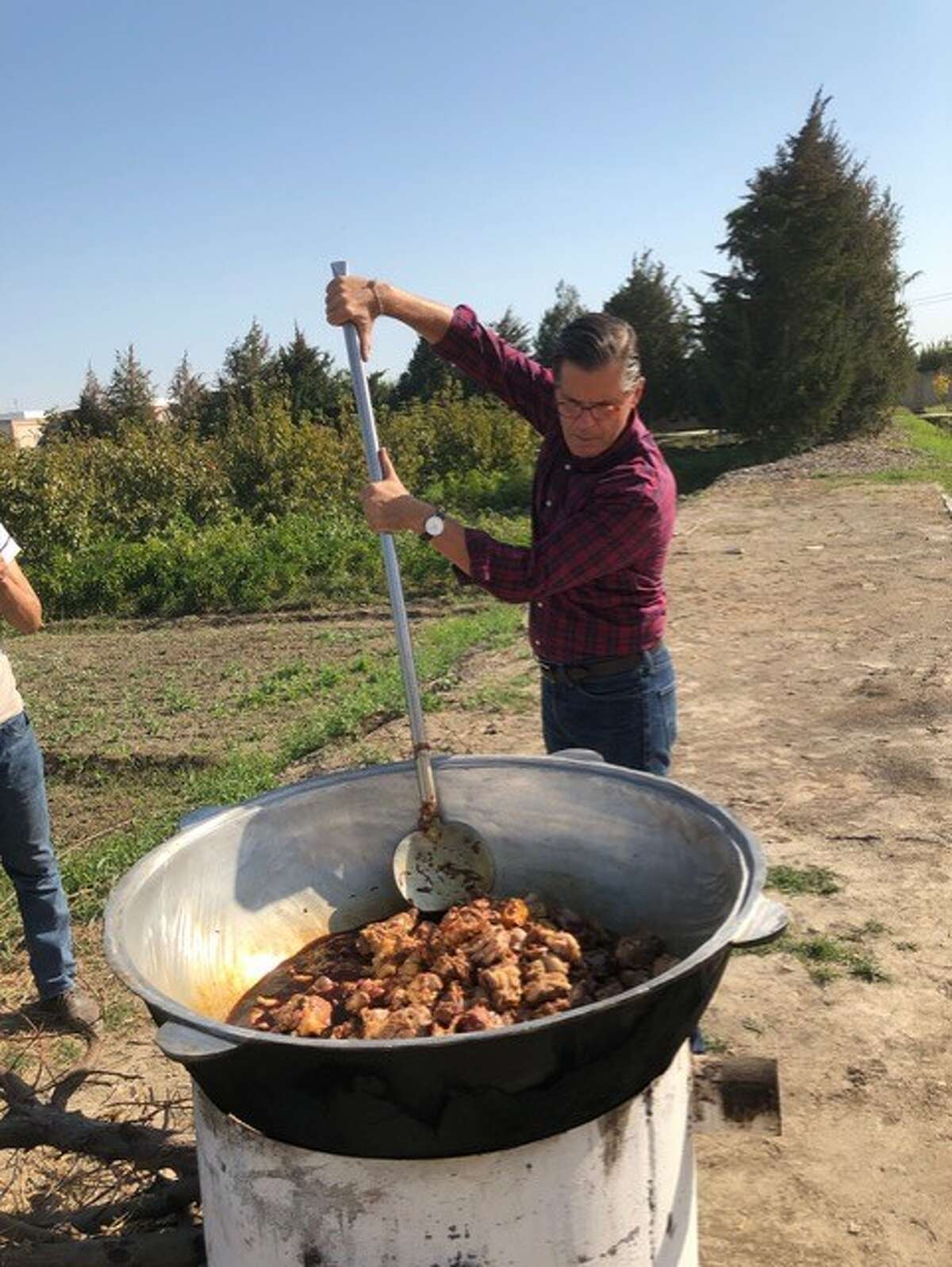 Foodie author Stephen Henderson has visited soup kitchens in Israel, Iran, Europe and all over America to figure out how to feed crowds cheaply but deliciously. Here, he works on a feast of roasted lamb for impoverished farmers in Uzbekistan. He calls his form of volunteering gastrophilanthropy.