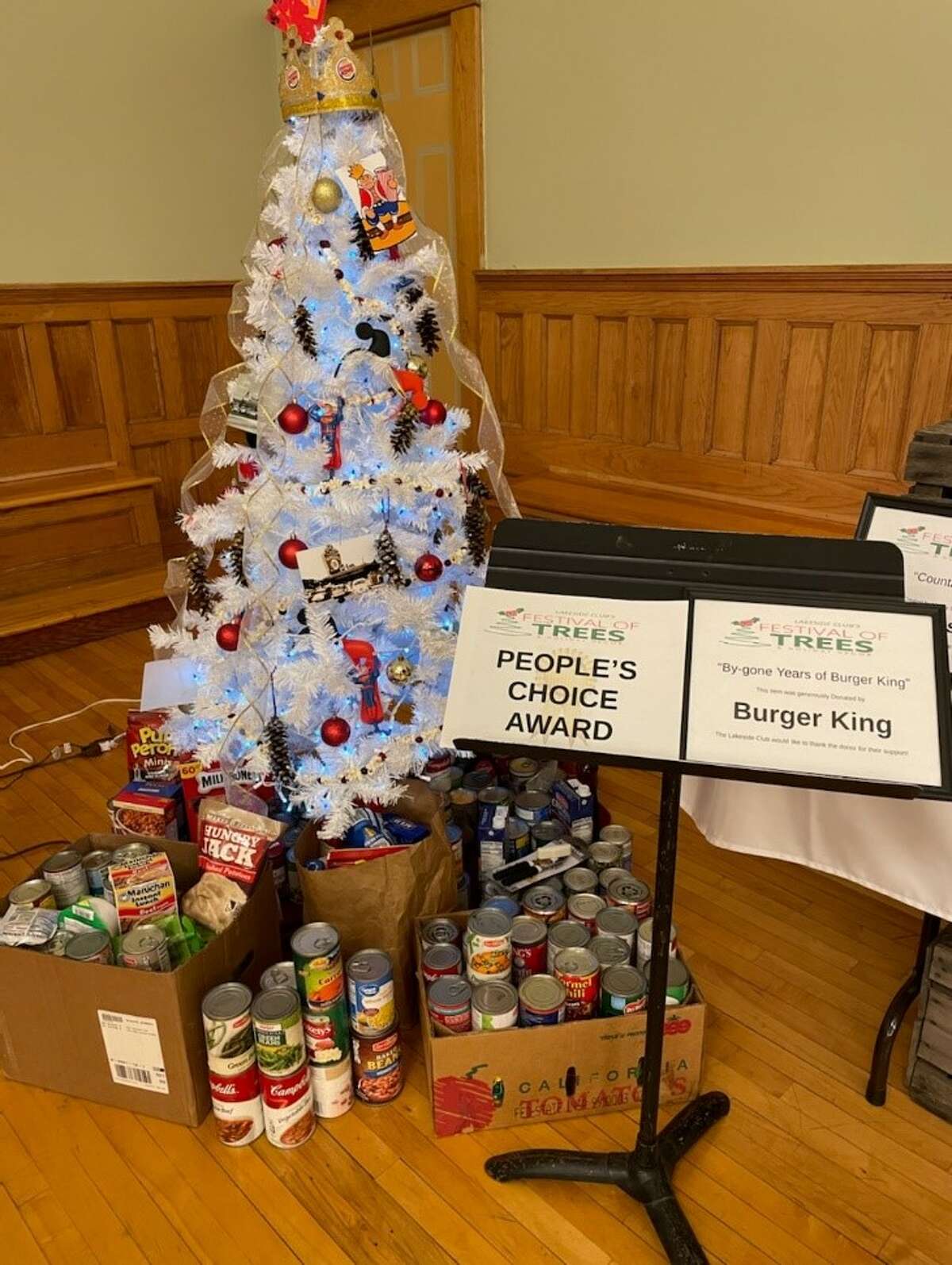 An entry by Burger King in Manistee won the People's Choice Award for the Festival of Trees & Decor. The winner for that award is chosen by the number of food items placed next to or under the tree. The Lakeside Club said that around 1,300 total food items to Matthew 25:35 Food Pantry.
