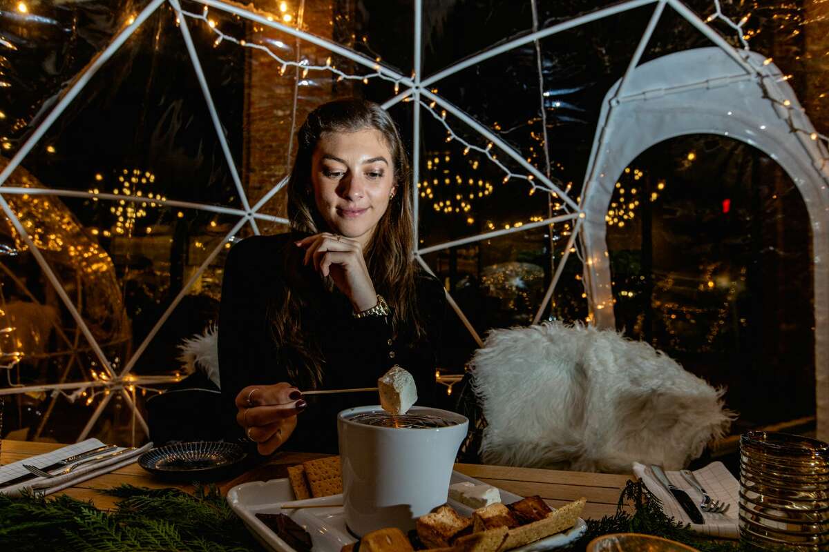 Outdoor diners make their own s'mores in the igloos at The Wheel in Stamford on Dec. 9, 2021.