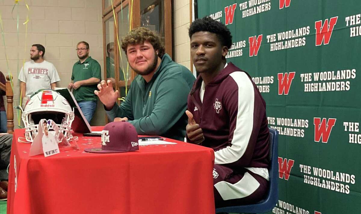 The Woodlands football players Kaden Sieracki, left, and Martrell Harris, right, participate in a National Signing Day ceremony at The Woodlands High School on Wednesday, Dec. 15, 2021.
