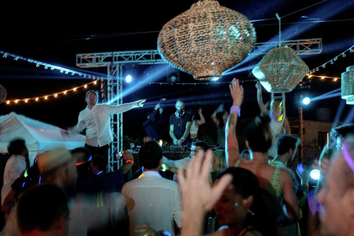 The wedding guests dance at the after party.