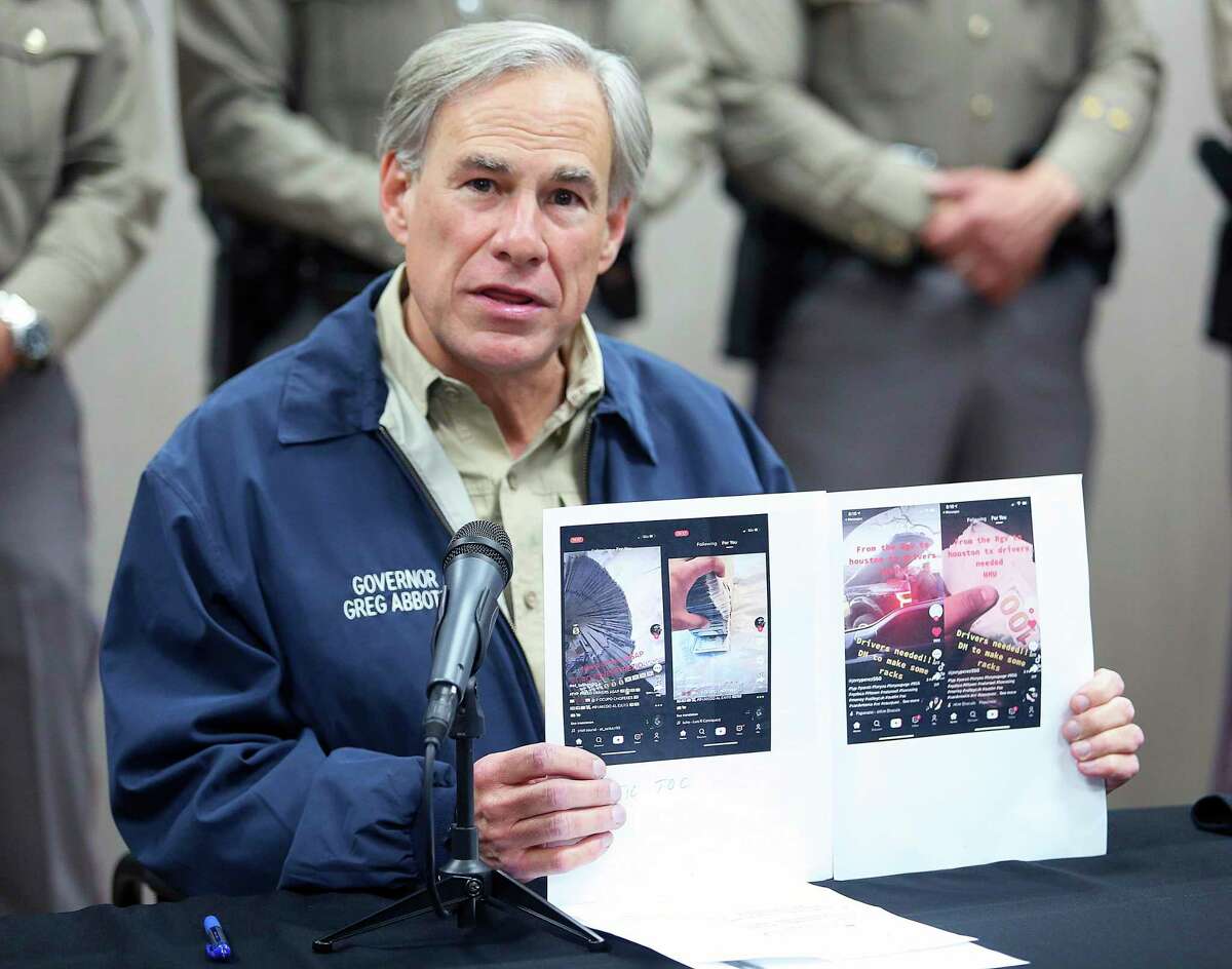 Texas Governor Greg Abbott displays screen shots of TikTok videos used by organized crime to recruit members gathered by law enforcement as he talks about Operation Lone Star during a press conference Texas Department of Public Safety Weslaco Regional Office on Thursday, April 1, 2021, in Weslaco, Texas. (Joel Martinez/The Monitor via AP)