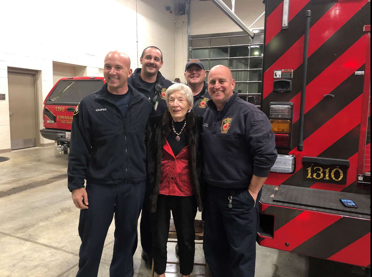 Angela Roepke III (center) posing with the Edwardsville Fire Department after delivering gift baskets to thank them for helping her the past couple years. 