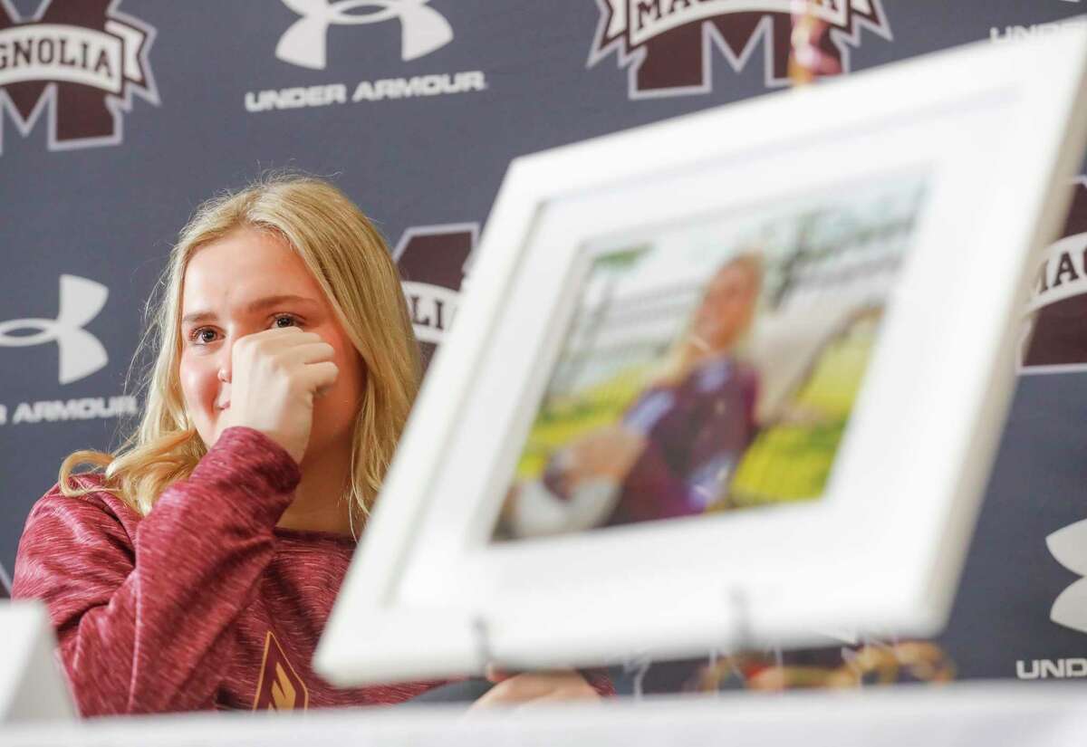 Brynn Botkin wipes away tears after her head coach Ashley Farris talks about having her as a player before signing to play volleyball for the University of Louisiana-Monroe, Wednesday, Dec. 15, 2021, in Magnolia.
