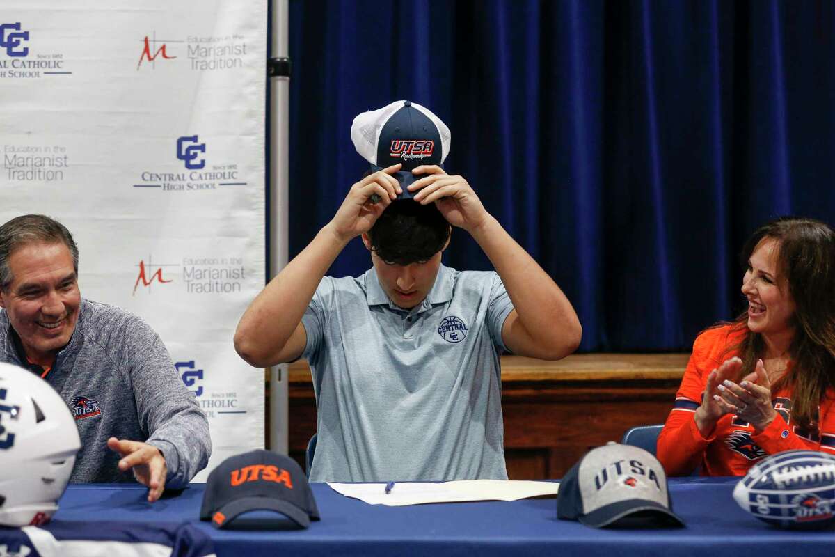 Central Catholic offensive lineman Ben Rios, joined by parents Raul and Irene, puts on a Roadrunners hat after signing with UTSA on Wednesday.