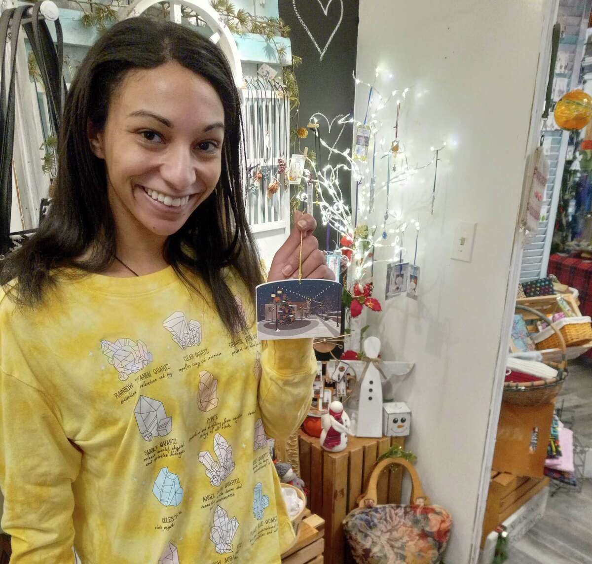 Jess Pitts at Kelly's Crystal's on Main Street in Torrington with one of the ornaments for sale this year.