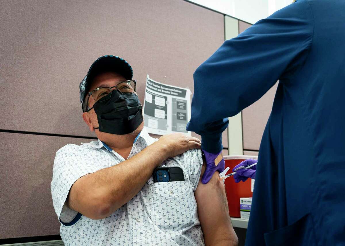 With the new coronavirus subvariants BQ.1 and BQ.1.1 on the rise, experts recommend being up-to-date on the new bivalent COVID-19 vaccine booster to prevent an infection. In this file photo, Ruben Martinez receives an earlier version of the booster shot at the Houston Health Department’s La Nueva Casa de Amigos Health Center on Dec. 10, 2021.