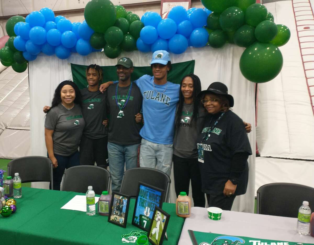 Legacy's Chris Brazzell II, third from right, poses with his family after he signed a letter-of-intent to play football at Tulane University on Wednesday at LHS. 