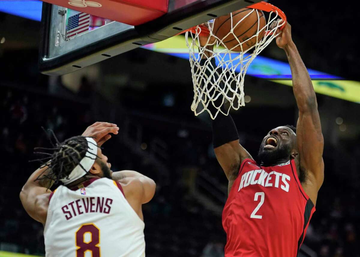 Houston Rockets' David Nwaba (2) dunks the ball over Cleveland Cavaliers' Lamar Stevens (8) in the second half of an NBA basketball game, Wednesday, Dec. 15, 2021, in Cleveland. The Cavaliers won 124-89. (AP Photo/Tony Dejak)