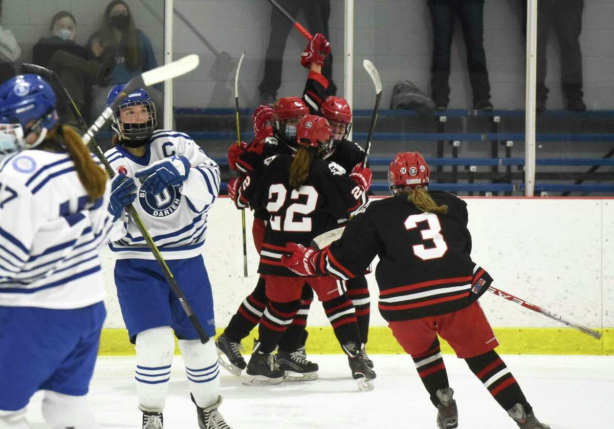 New Canaan celebrates Kaleigh Harden's game-tying goal in the third period during a girls ice hockey game against Darien at the Darien Ice House on Saturday, March 6, 2021.