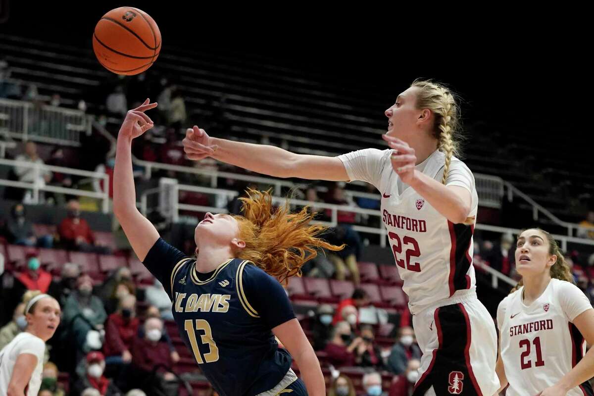Stanford forward Cameron Brink (22) blocks a shot attempt by UC Davis guard Sydney Burns (13) during the first half of an NCAA college basketball game in Stanford, Calif., Wednesday, Dec. 15, 2021. (AP Photo/Jeff Chiu)