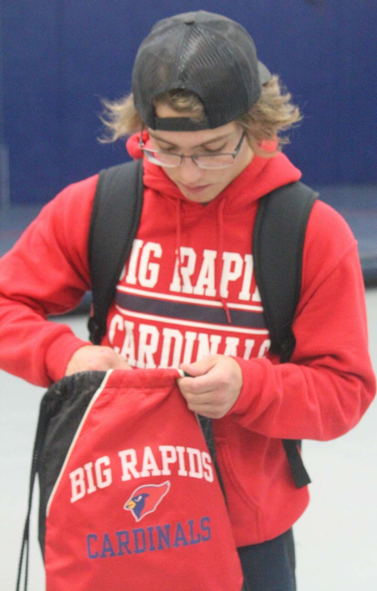 Brett Rupe packs up his things after having a 1-1 wrestling night for the Cardinals on Wednesday.