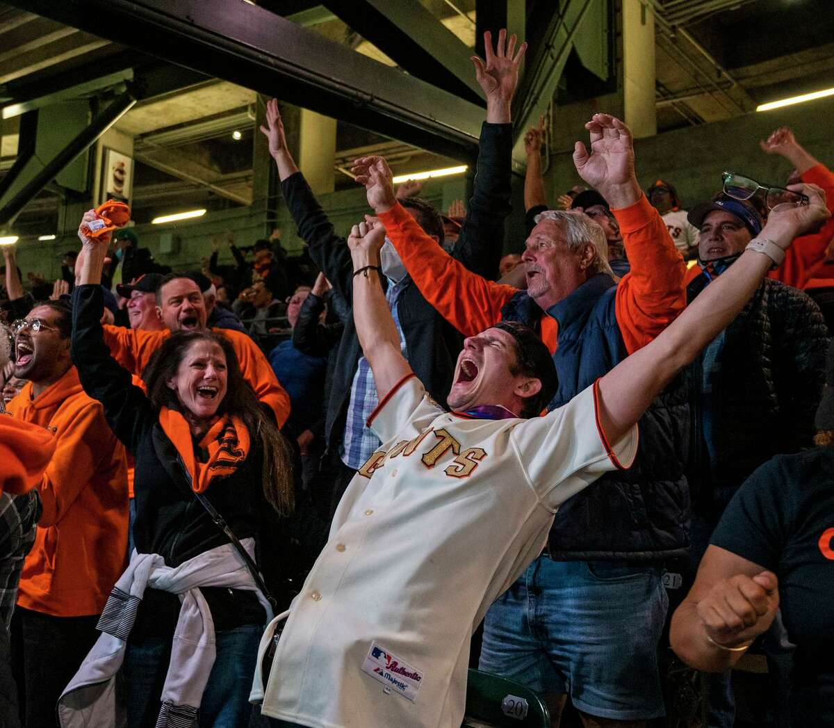Tony and Michele Lewis of Saratoga react with joy as the Giants score in the 6th inning of Game 5 of the San Francisco Giants vs the Los Angeles Dodgers National League Division Series at Oracle Park. Photographed in San Francisco, California on October 14, 2021.