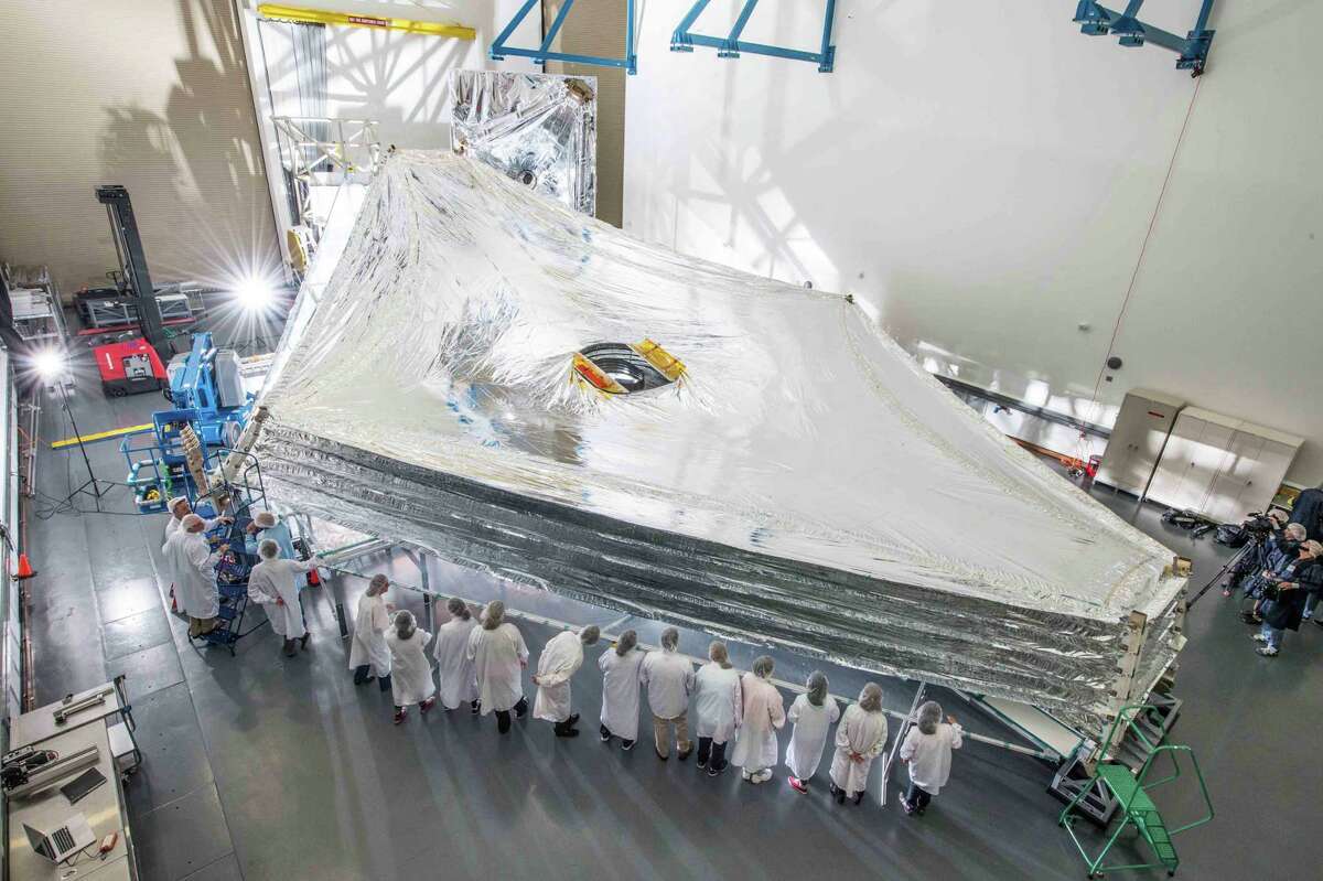This photo from 2017 shows the sunshield for NASA's James Webb Space Telescope. The sunshield is the largest part of the observatory—five layers of thin membrane that must unfurl reliably in space to protect the telescope from light and heat emitted from the sun, Earth, and moon.