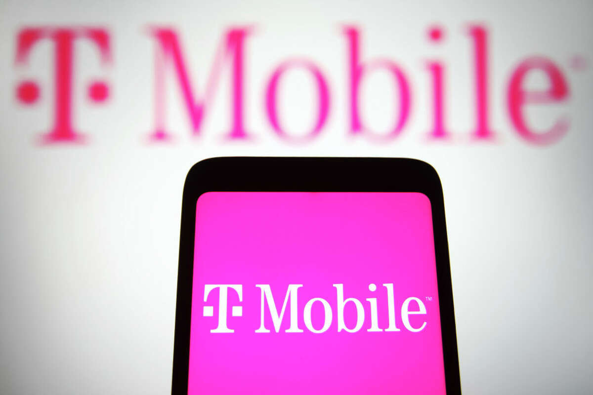 In this photo illustration, a T-Mobile US Inc. logo is seen on a smartphone and a pc screen. (Photo Illustration by Pavlo Gonchar/SOPA Images/LightRocket via Getty Images)