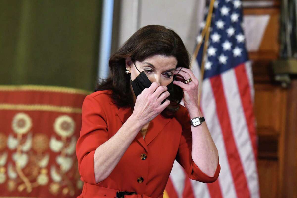 Gov. Kathy Hochul puts her face mask on following a coronavirus news briefing where she discussed the potential dangers faced by spread of the new omicron COVID-19 variant on Thursday, Dec. 16, 2021, in the Red Room at the Capitol in Albany, N.Y.