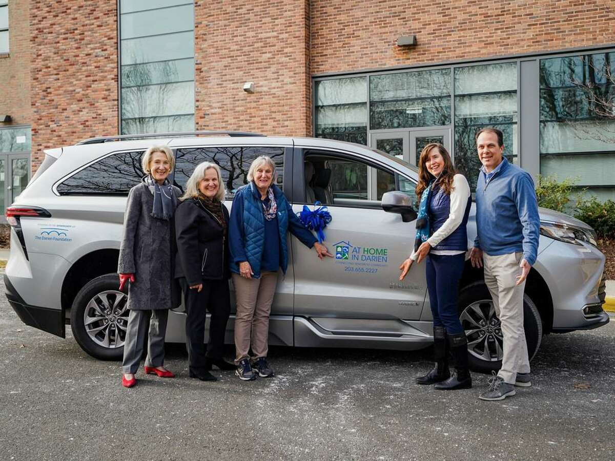 Members of The Darien Foundation and At Home In Darien gather with a new handicap-accessible “supervan.” The vehicle was purchased through a grant from The Darien Foundation.