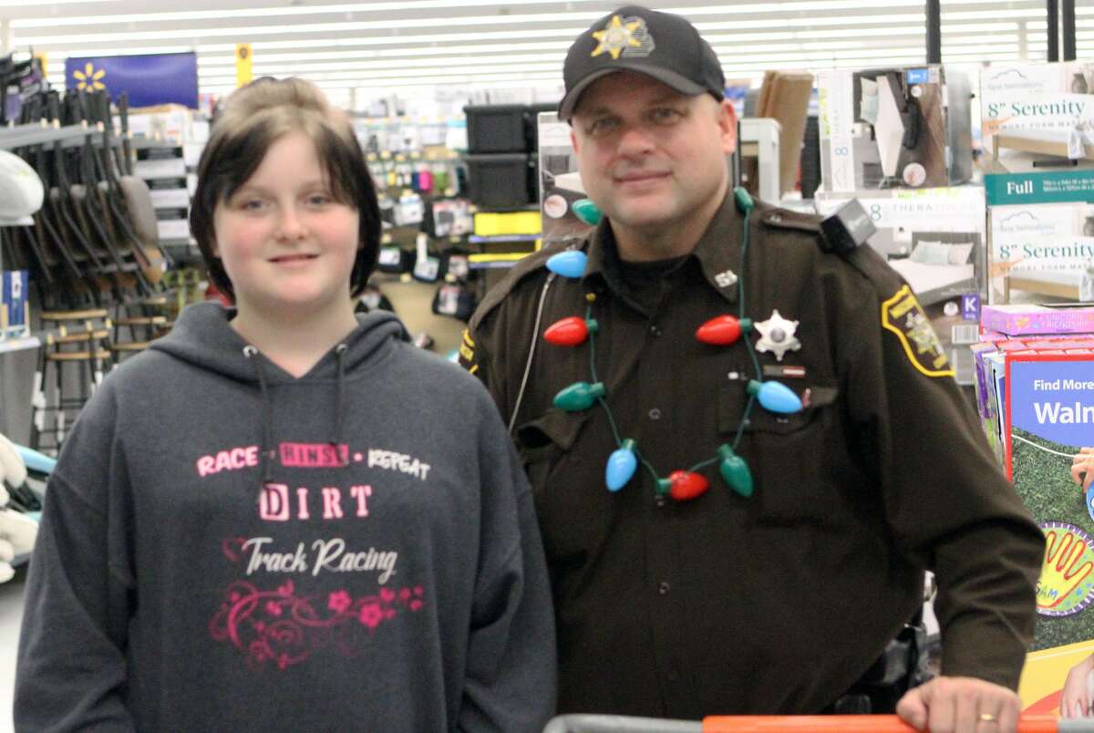 Big Rapids Middle School student Savanna Skaggs and Deputy Joe Marshall were paired together for Wednesday night's Shop With a Hero event. 