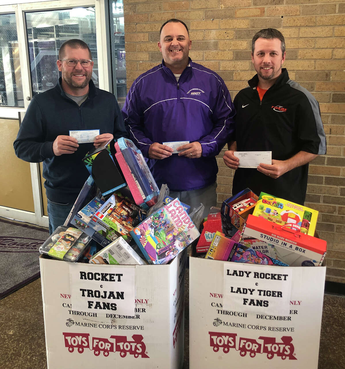 Rich Thompson (from left), athletic director at Triopia High School; Barry Creviston, athletic director at Routt Catholic High School; and Joe Pembrook, athletic director at Greenfield High School donated $5 for every 3-pointer made during their Dec. 6 and 7 games to Toys for Tots. Many toys also were collected from those attending the game to be donated to Toys for Tots.
