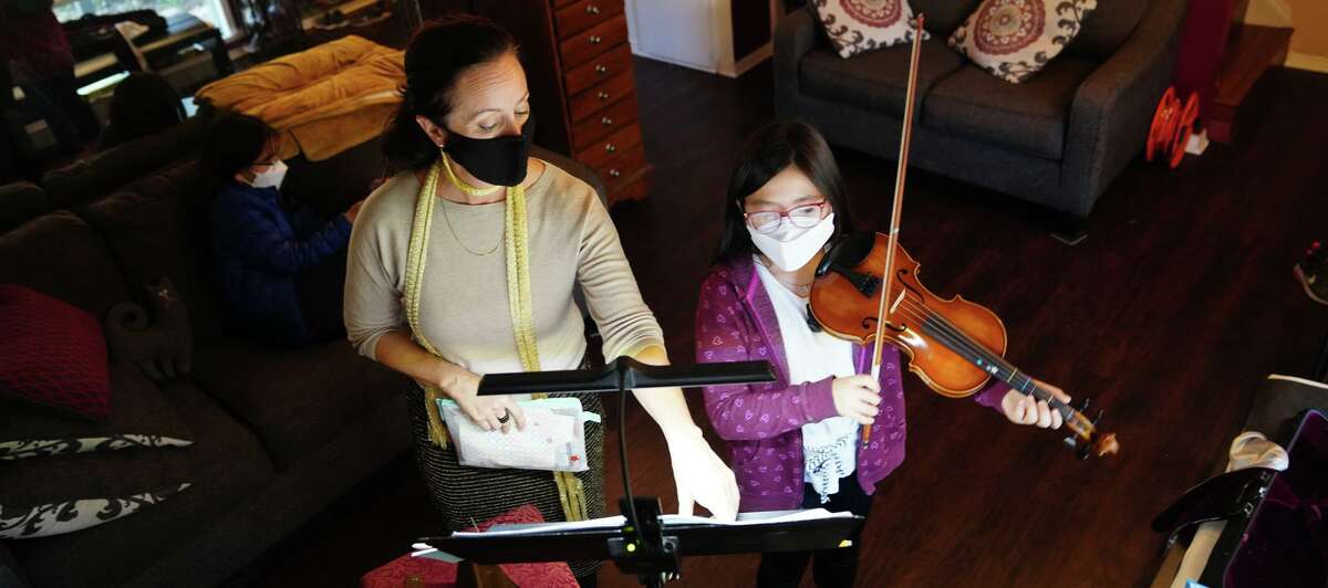 San Antonio Symphony violinist Angela Caporale gives a private lesson in her home to Julia Suk.