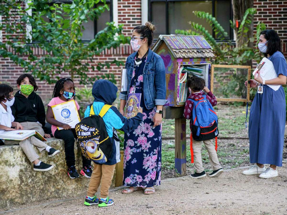 Teachers and students outside Lamar Elementary School the day after its district mandated masks, in San Antonio, Texas, Aug. 12, 2021.