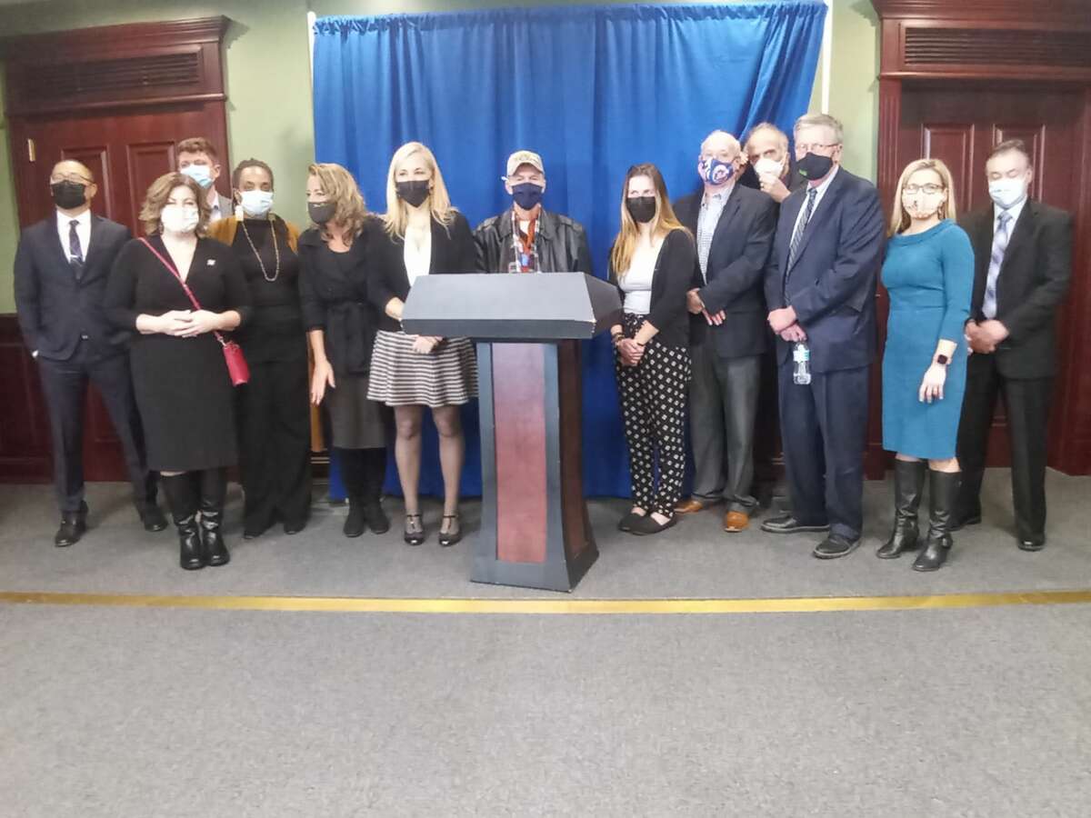 Speakers gather for a picture at a forum for mental health and substance use disorder advocacy organizations at the Legislative Office Building in Albany, N.Y on Thursday, Dec. 16, 2021. They are asking Gov. Kathy Hochul for a $500 million investment into funding their services statewide.