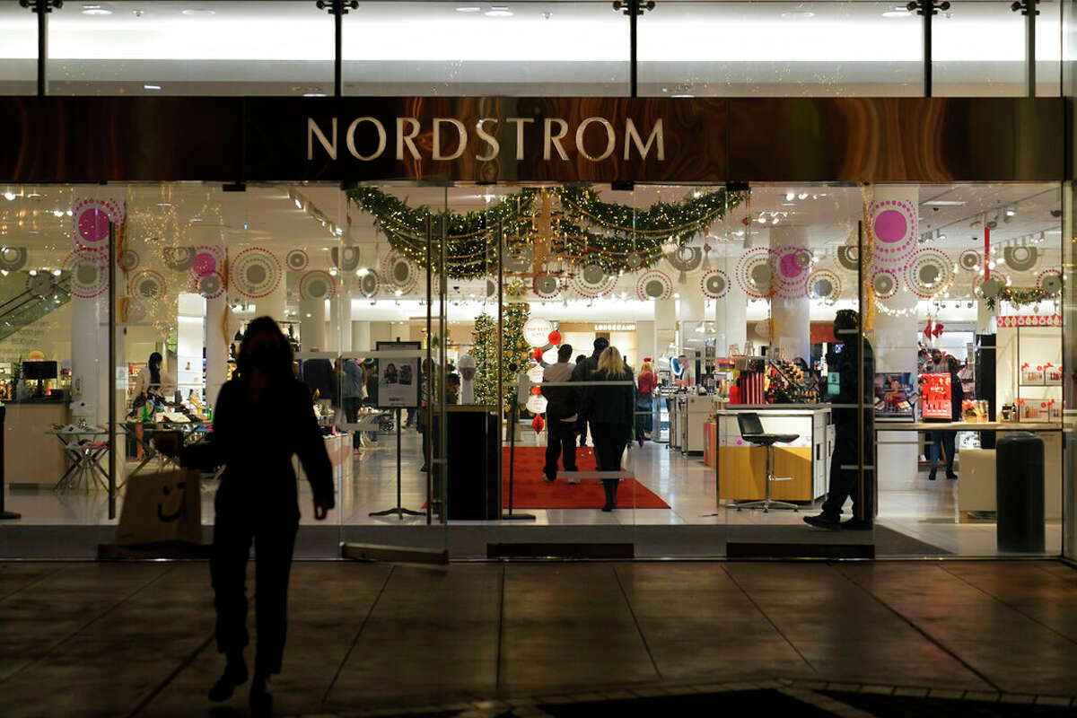 A security guard stands at the entrance to a Nordstrom department store where a recent smash-and-grab robbery took place.