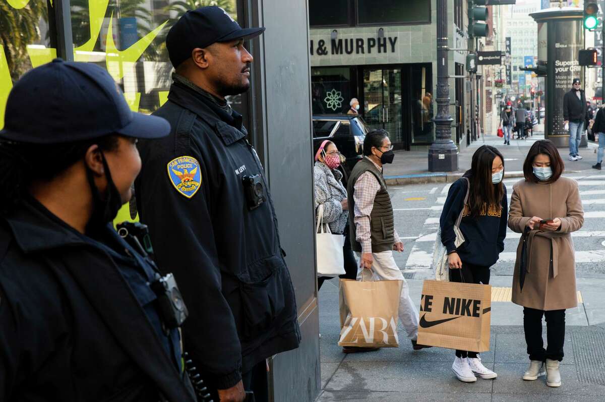 San Francisco police officers stand guard outside of the Nike store at Union Square in San Francisco on Nov. 26.