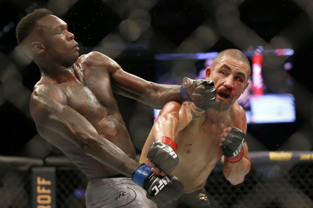 MELBOURNE, AUSTRALIA - OCTOBER 06: Israel Adesanya punches Robert Whittaker between in their Middleweight title bout during UFC 243 at Marvel Stadium on October 06, 2019 in Melbourne, Australia. (Photo by Darrian Traynor/Getty Images)