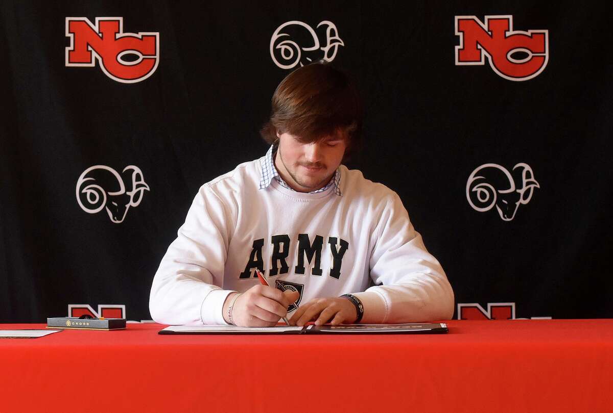 New Canaan’s Ned Brady signs his National Letter of Intent to play football for Army during a ceremony in New Canaan’s Waveny House on Wednesday.