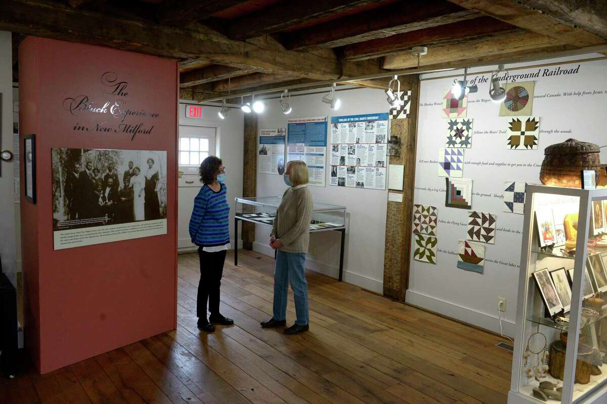 Anita Regan, left, and Kathy Kelly, members of the New Milford Historical Society’s board, stand in the Society’s new permanent exhibit The Black Experience in New Milford. Wednesday, December 15, 2021, New Milford, Conn.