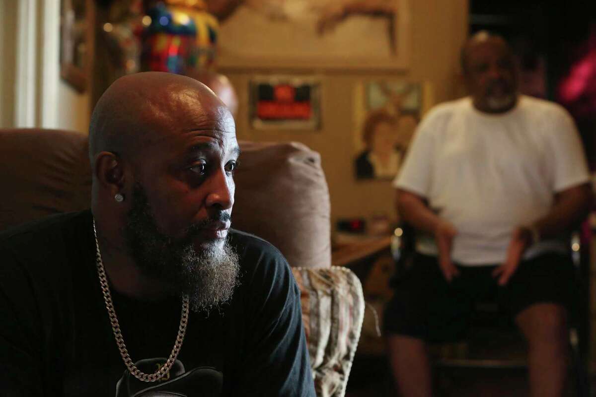 Eric Wilson sits with his father, Eddie Wilson Sr., in the father’s East Side home on Thursday, Dec. 16, 2021.