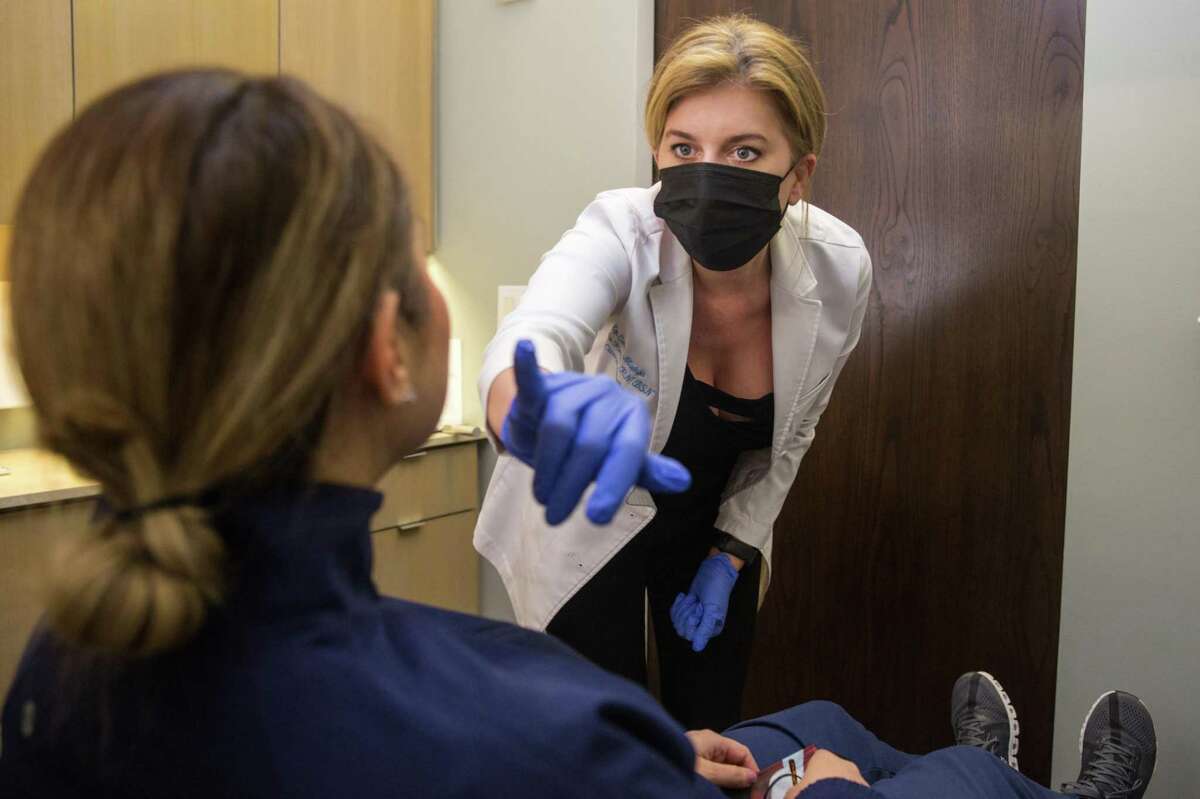 Clinic director Heather Hodges talks to client Jackie Mayorga before her Botox treatment at Epi Center MedSpa in San Francisco.