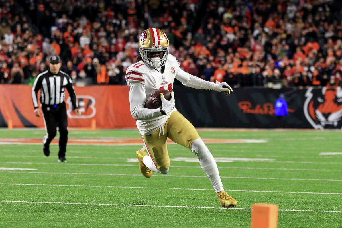 San Francisco 49ers wide receiver Brandon Aiyuk (11) runs with the ball after making a catch during an NFL football game against the Cincinnati Bengals, Sunday, Dec. 12, 2021, in Cincinnati. San Francisco won 26-23 in overtime. (AP Photo/Aaron Doster)