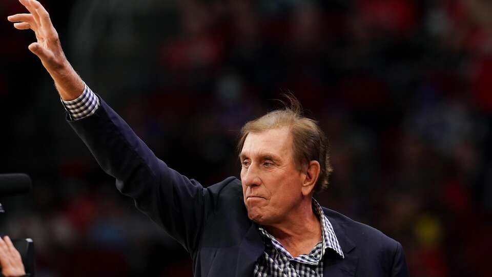 Former Houston Rocket player and coach Rudy Tomjanovich waves to the crowd after being recognized during a time out between the Houston Rockets host New York Knicks at the Toyota Center in Houston on Thursday, Dec. 16, 2021. Tomjanovichâ€™s jersey was raised in honor of his 2020 induction into the Hall of Fame.