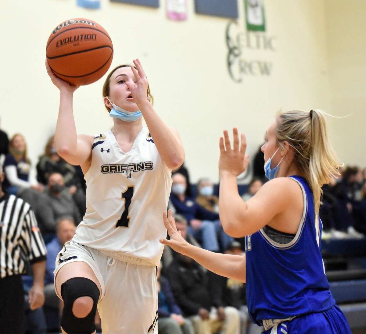 Father McGivney's Mary Harkins puts up a shot over Marquette Catholic's Hayley Porter during the first half in Glen Carbon.